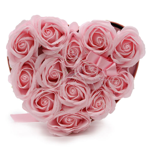 Heart-shaped box filled with pink roses on a white background