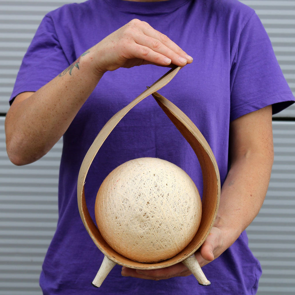 Person holding a coconut lamp