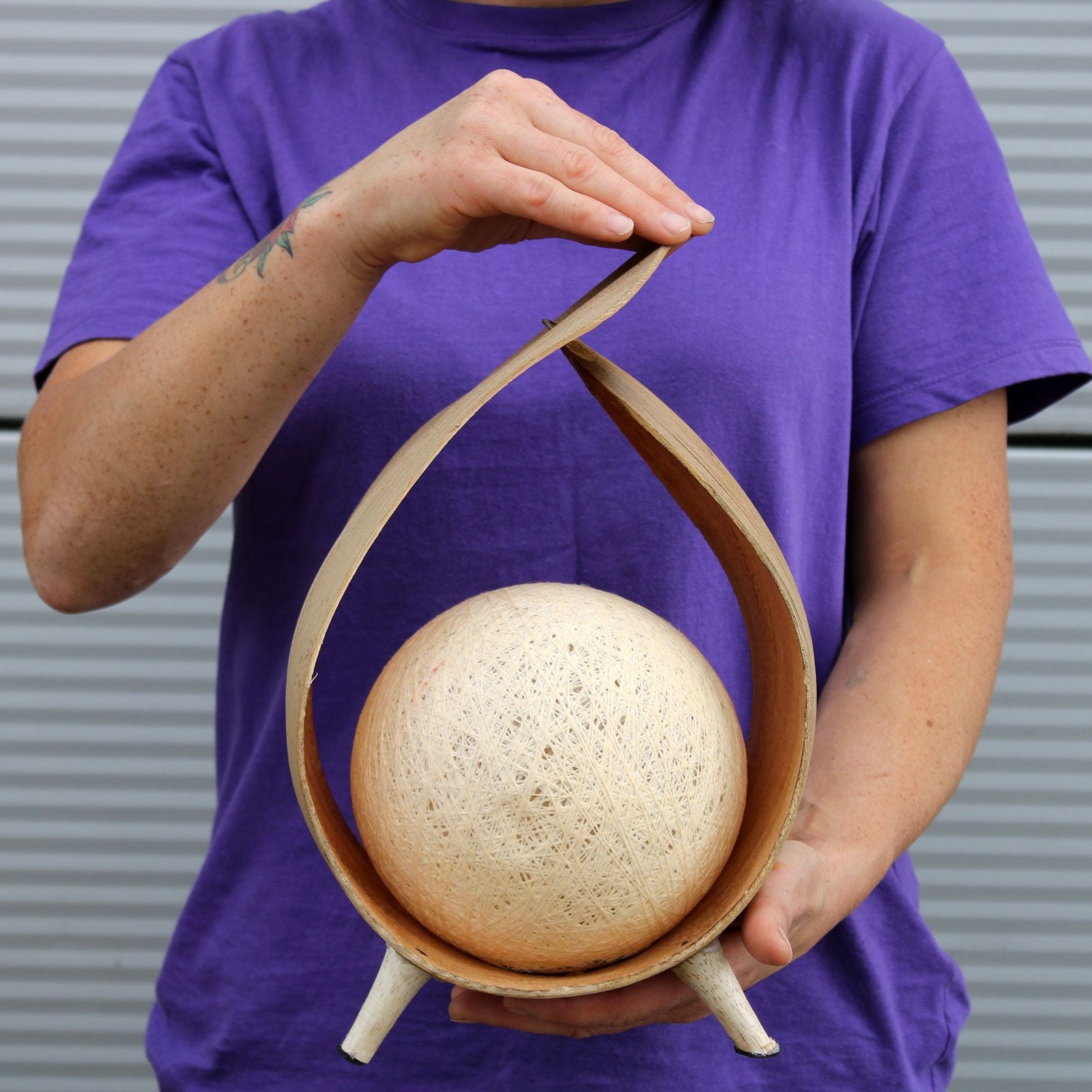 Person holding a coconut lamp
