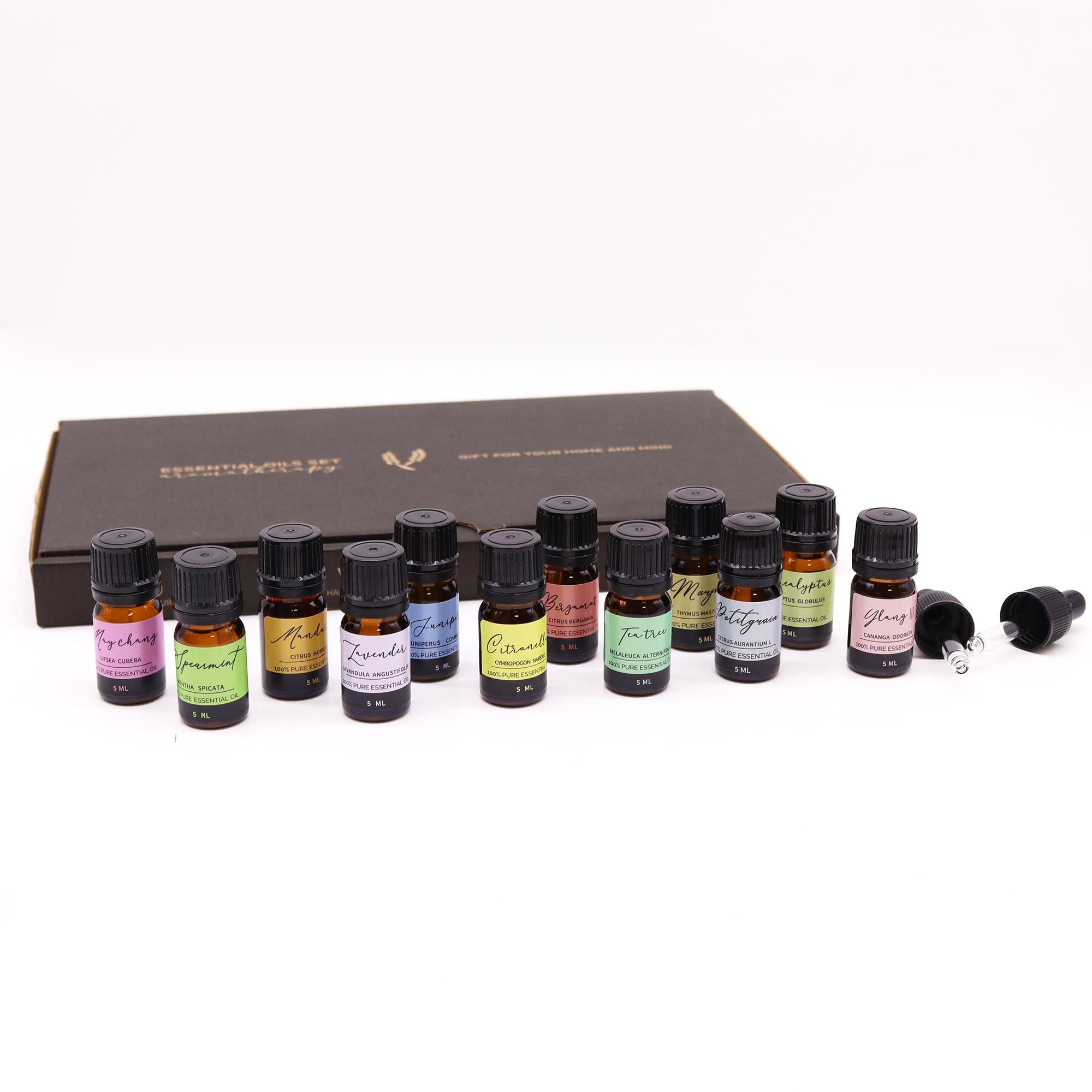 Set of essential oil bottles with black caps on a white background