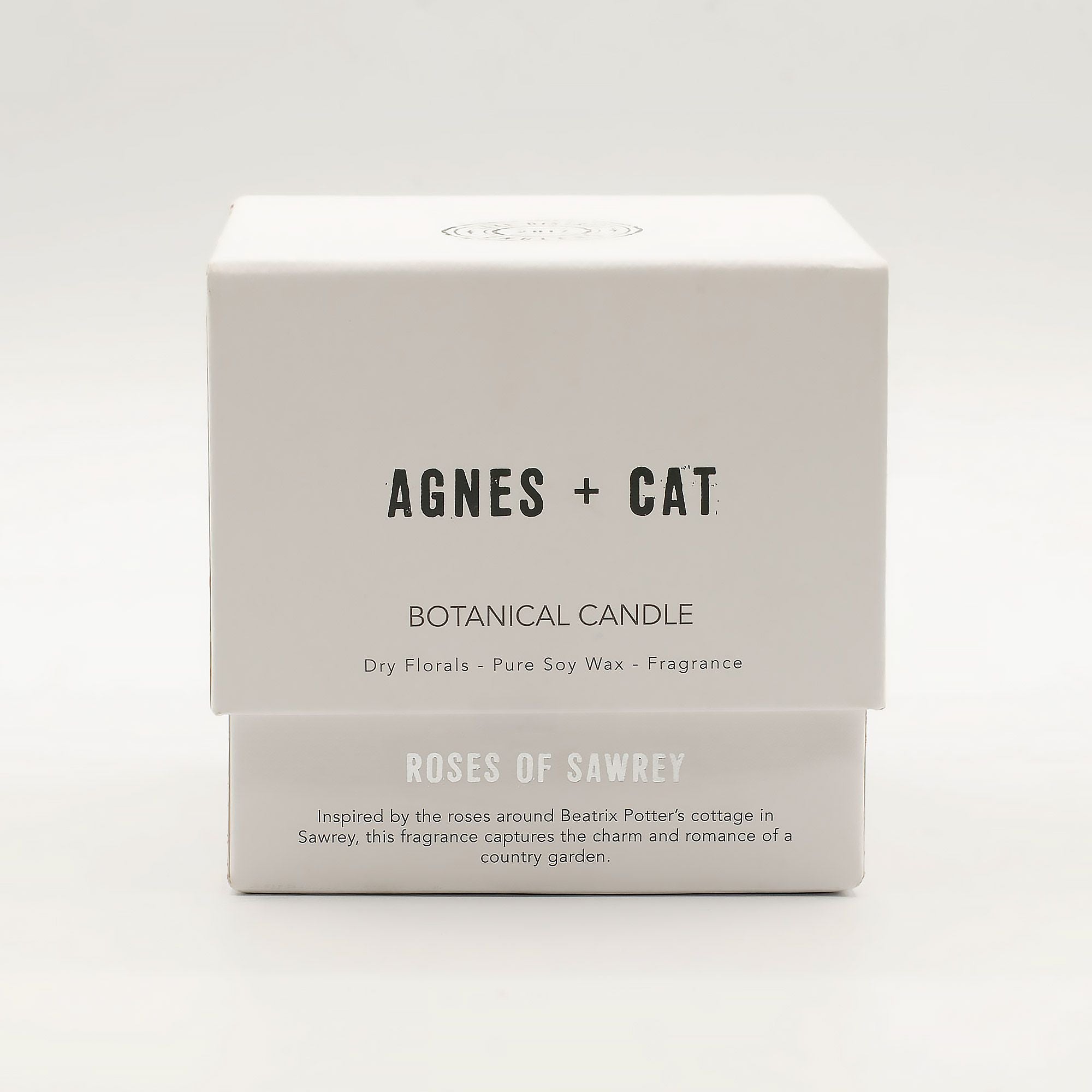 Box of Agnes + Cat botanical candle on a white background