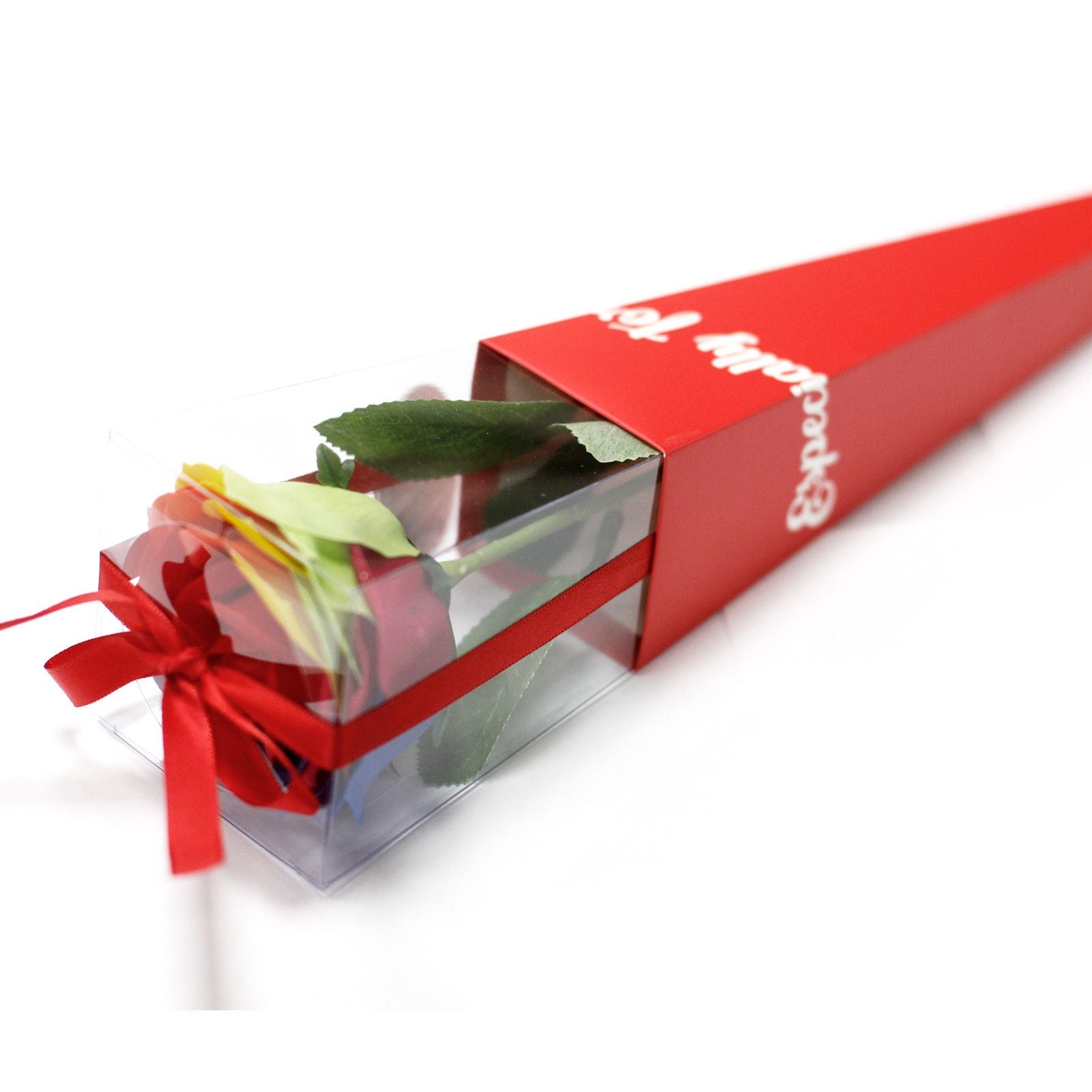 Bouquet of flowers wrapped in clear plastic with a red ribbon and box on a white background